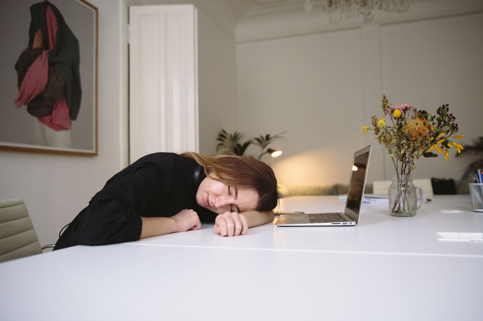 Mujer descansando con los ojos cerrados en una silla de oficina
